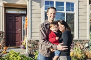 Home Inspector Tampa Denver Home Inspectors couple with their son standing in front of their house
