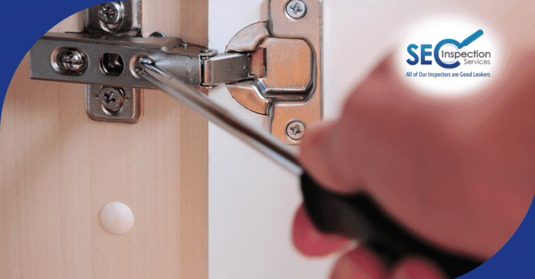Technician tightening cabinet hinge screws.