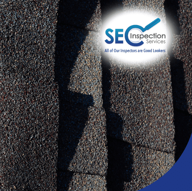 Close-up of asphalt shingles with hail impact marks, showing roof damage inspection