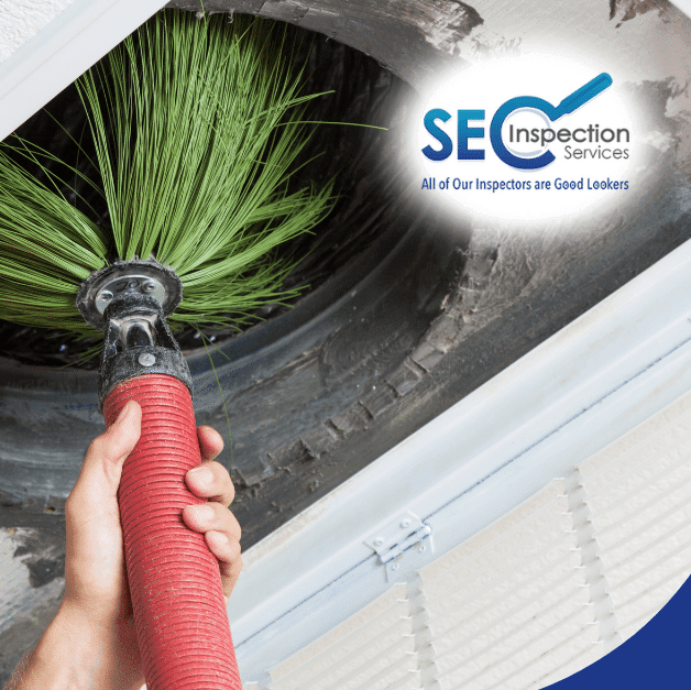 Person using a hose to clean an HVAC vent with a brush attachment.